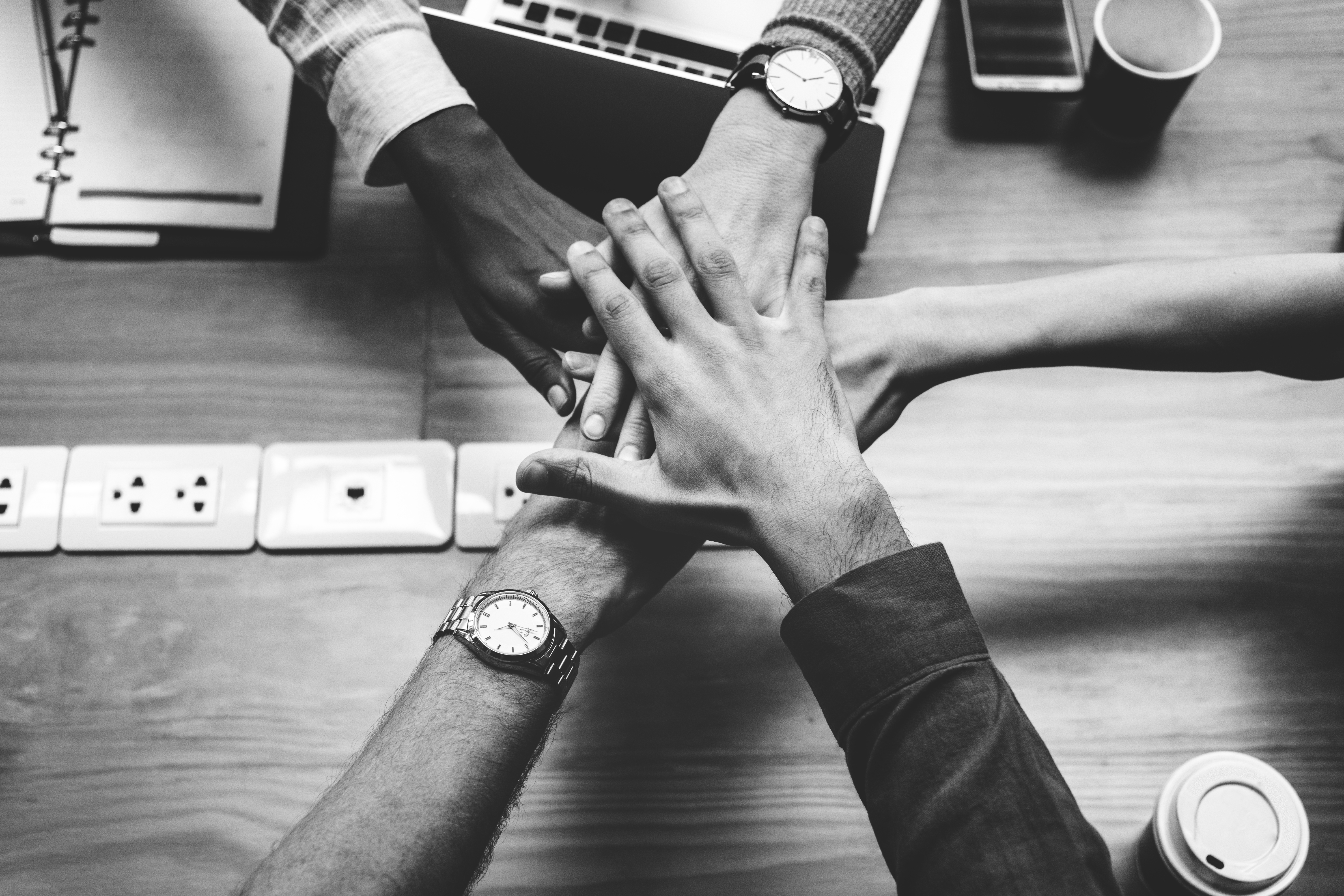 Hands of people together in a team, signifying involvement and partnership.